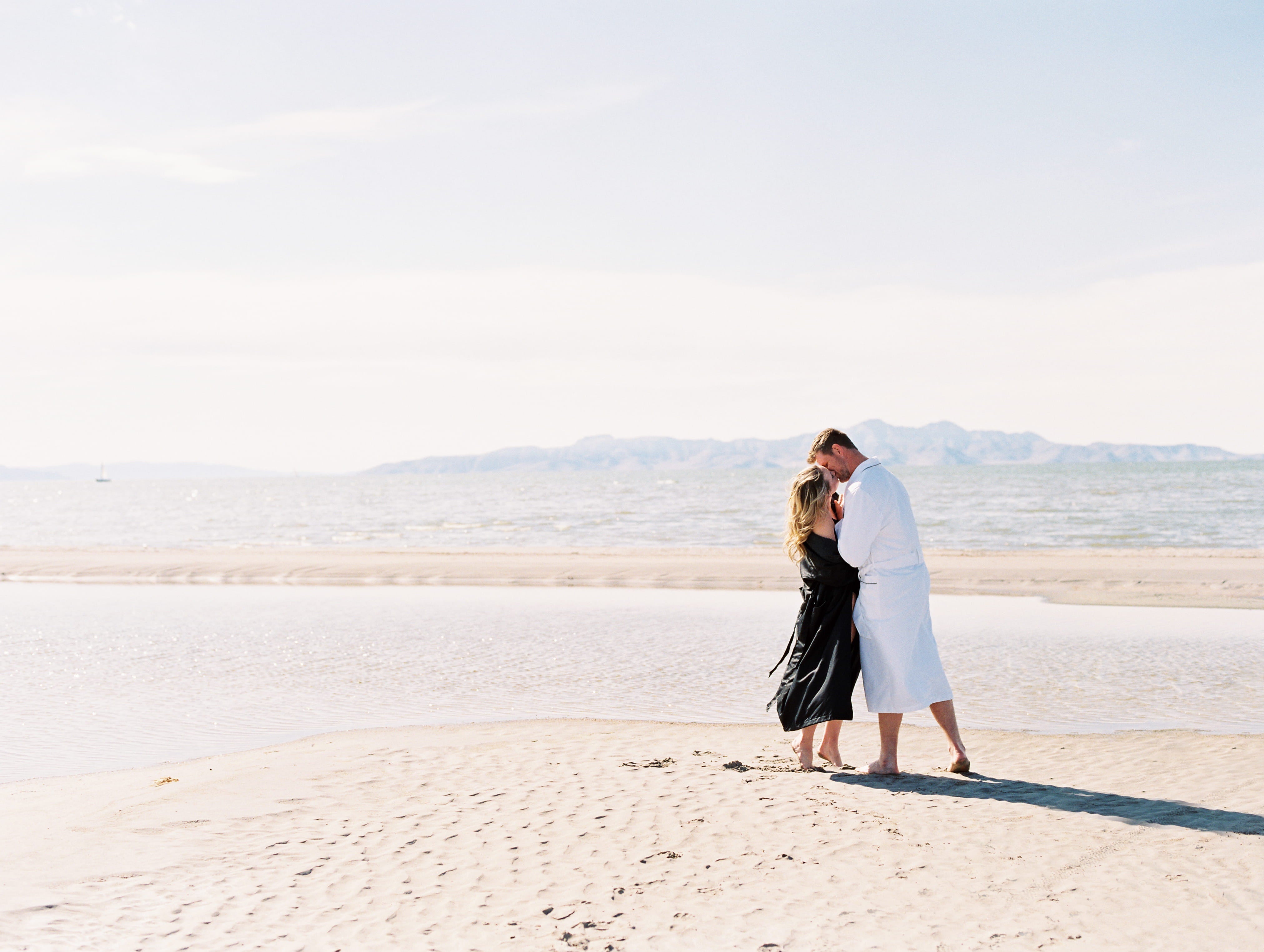 man and woman in bathrobe at salt lake